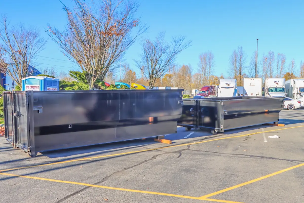 Professional dumpster rental service with roll-off container on residential driveway in South Salt Lake